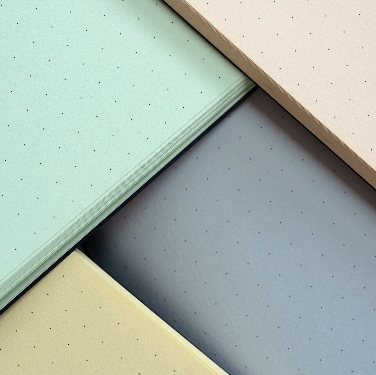 Four different colored textured sheets arranged in a pattern.